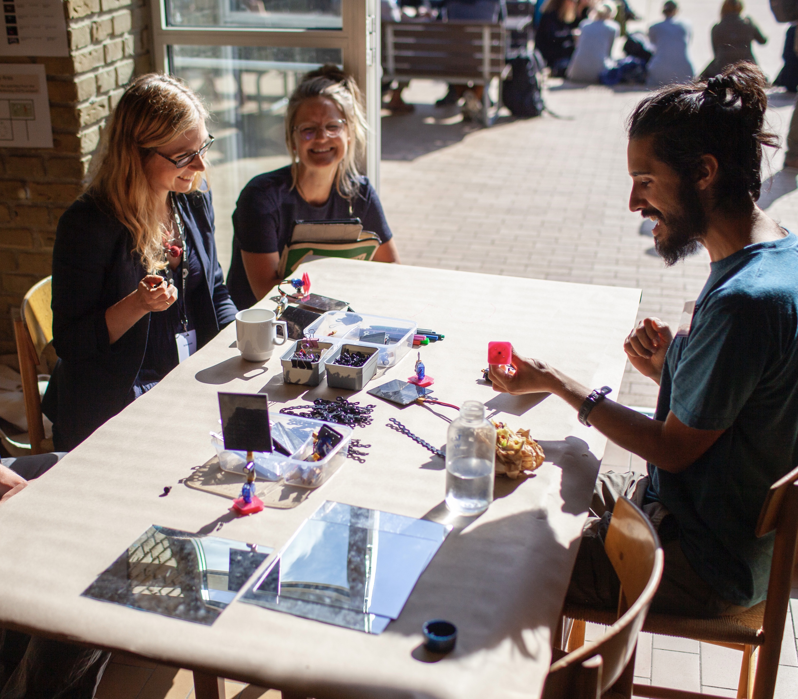 (Article Figure 2) Participants at the worktable at the start of prototyping session.